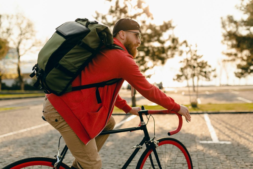handsome bearded man traveling with bicycle in morning